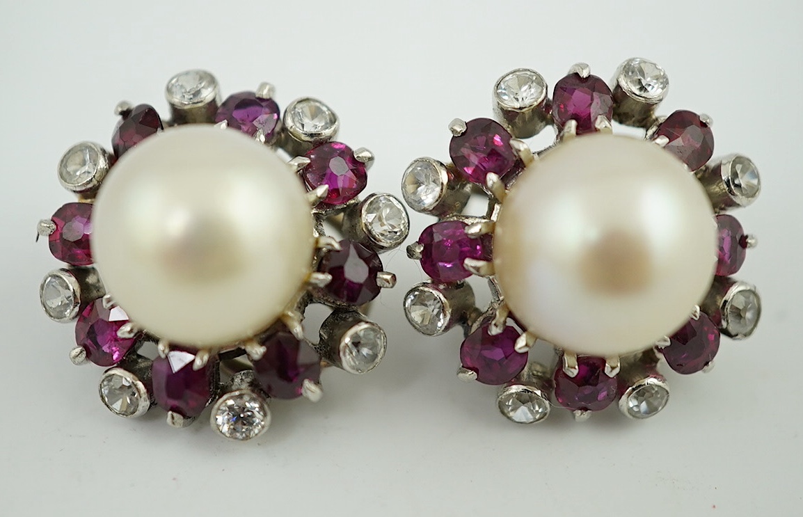 A pair of pearl earrings, with ruby and simuluated diamond surrounds, unmarked, 8.2 g gross. Condition - fair